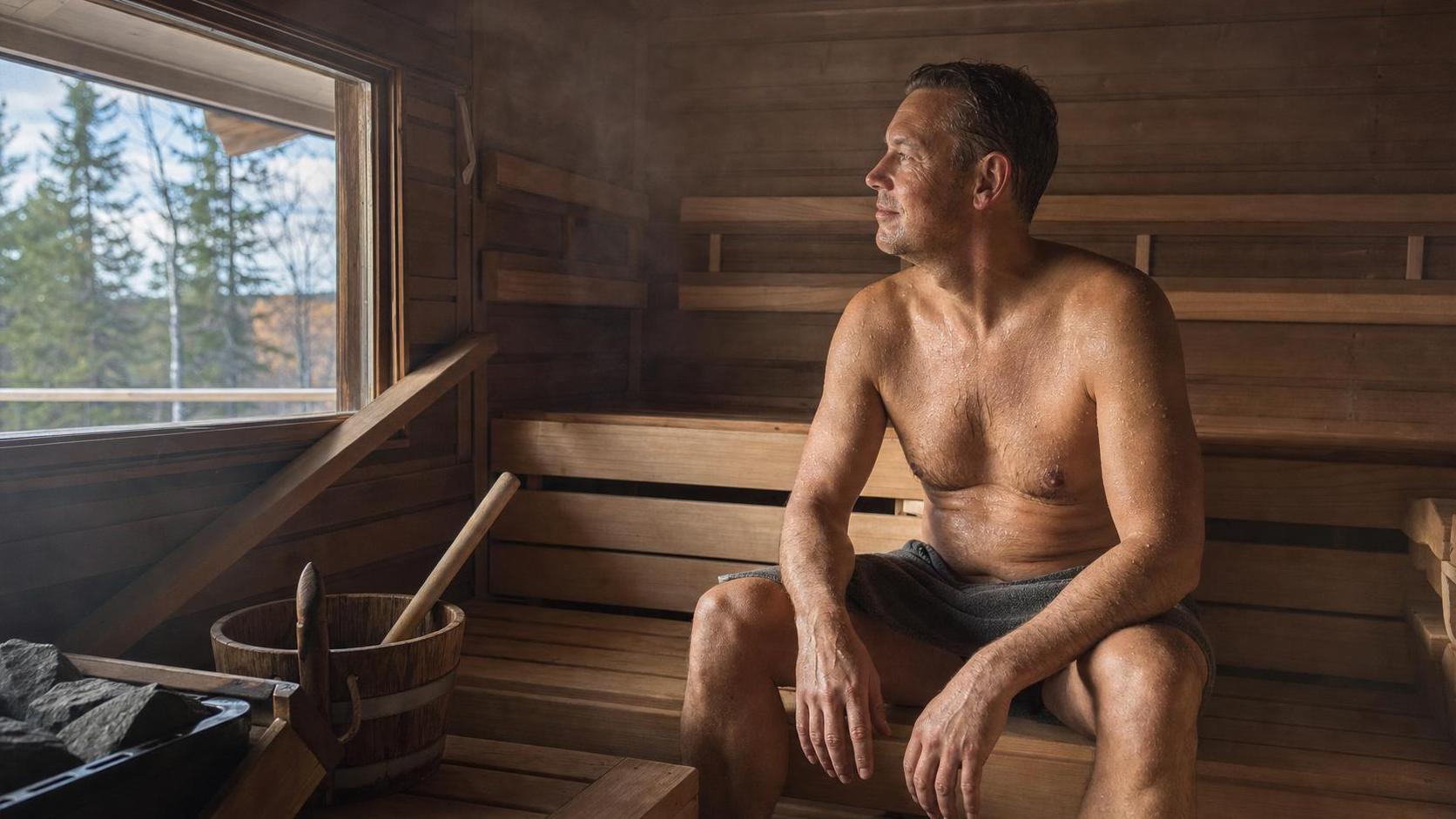 Adult relaxing in a traditional Finnish sauna