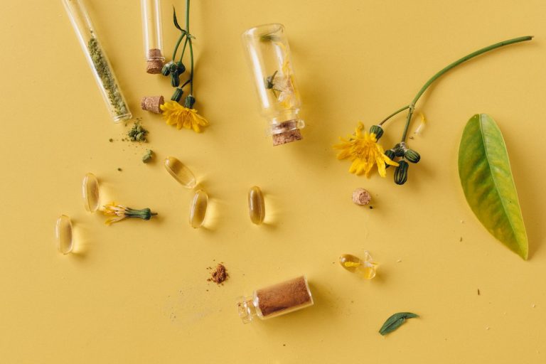 Herbal supplement capsules on yellow surface, curcumin side effects | Healthcare Discovery