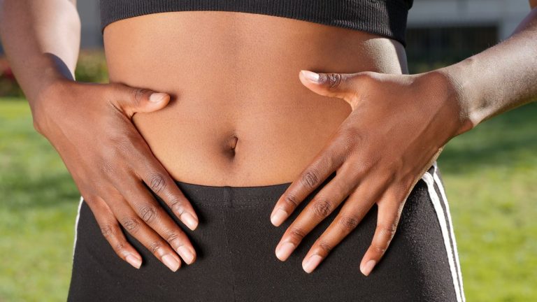 Hands resting on abdomen, collagen gut health claims | Healthcare Discovery