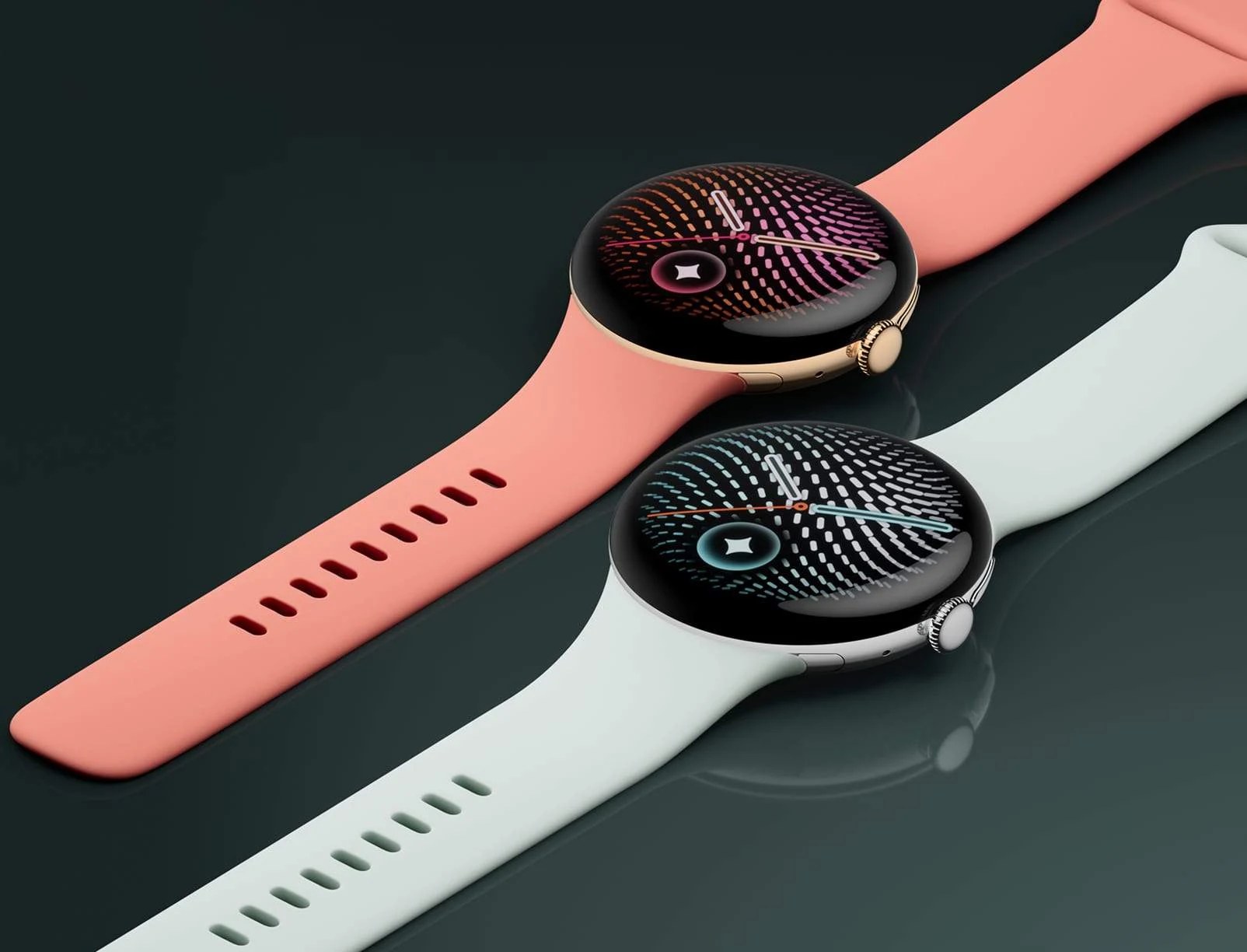 Two Google Pixel Watch 5 watches, one with a coral band and one with a light gray band