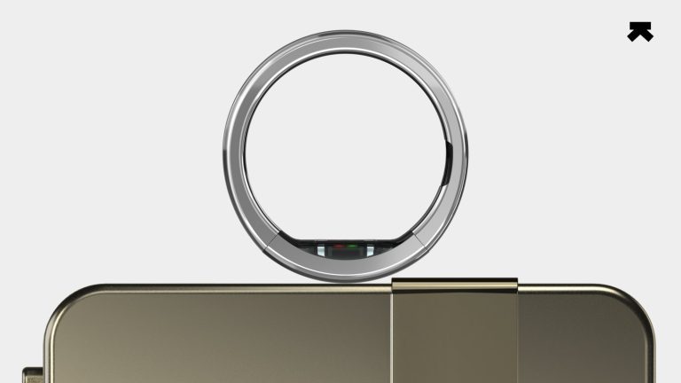 Ultrahuman Ring Pro titanium smart ring resting on its charging case